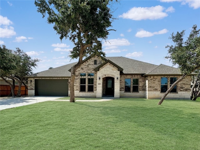 view of front of home with a garage and a front yard