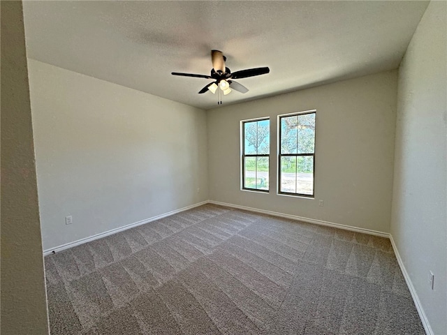 carpeted empty room featuring a textured ceiling and ceiling fan