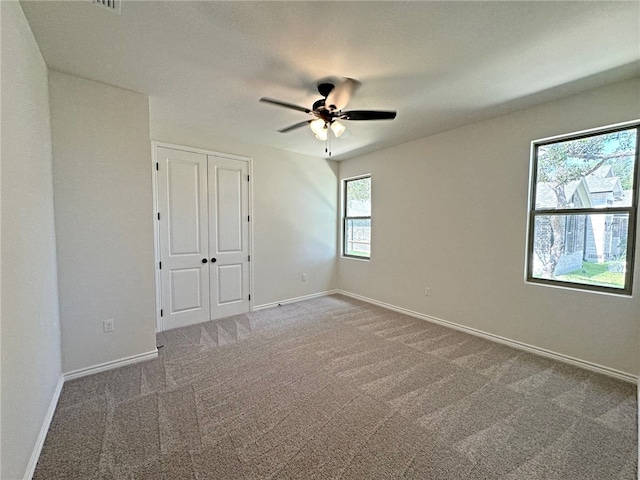 carpeted empty room with ceiling fan