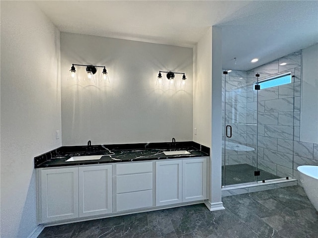 bathroom with vanity and shower with separate bathtub