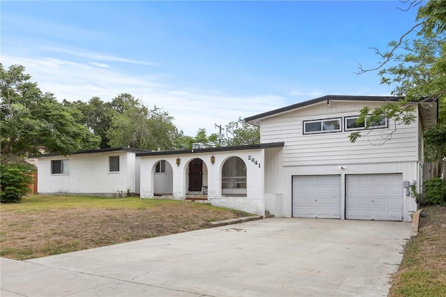 2641 Linn, Corpus Christi, TX 78410 - view of front of home featuring concrete driveway, an attached garage, and a front yard