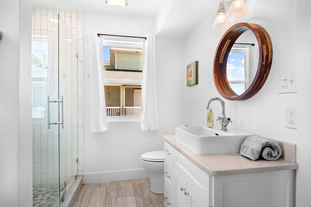 411 S 12th St, Port Aransas, TX 78373 - full bathroom featuring a stall shower, vanity, and wood finished floors