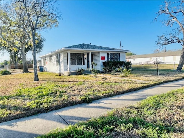 view of front of property with a front yard and fence