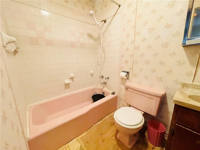 bathroom featuring toilet, vanity, wallpapered walls, and bathing tub / shower combination