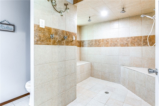 full bath featuring tile patterned flooring, a tile shower, and toilet