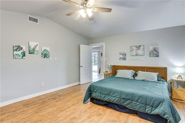 bedroom with baseboards, vaulted ceiling, light wood-style flooring, and visible vents