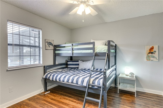bedroom with baseboards, a ceiling fan, a textured ceiling, and wood finished floors