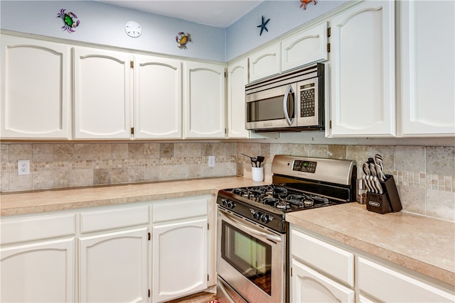 kitchen featuring light countertops, appliances with stainless steel finishes, backsplash, and white cabinets