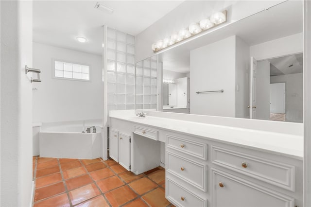 bathroom with a bath, tile patterned flooring, and vanity