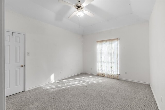 spare room featuring light colored carpet and ceiling fan