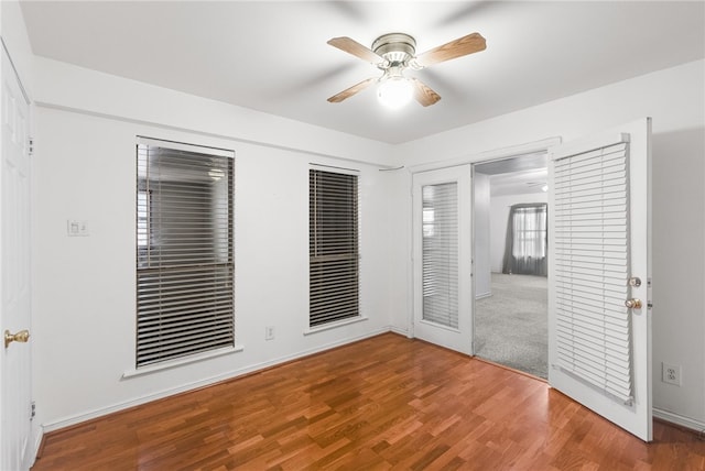 unfurnished bedroom with wood-type flooring, ceiling fan, and a closet