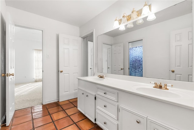 bathroom featuring vanity, a healthy amount of sunlight, and tile patterned floors