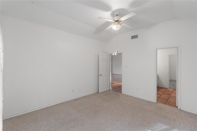 unfurnished bedroom with ceiling fan, lofted ceiling, and light colored carpet