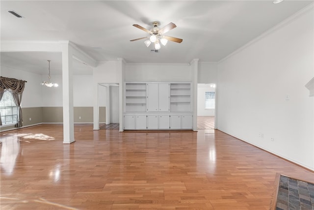 interior space with built in features, ceiling fan with notable chandelier, crown molding, and light hardwood / wood-style flooring