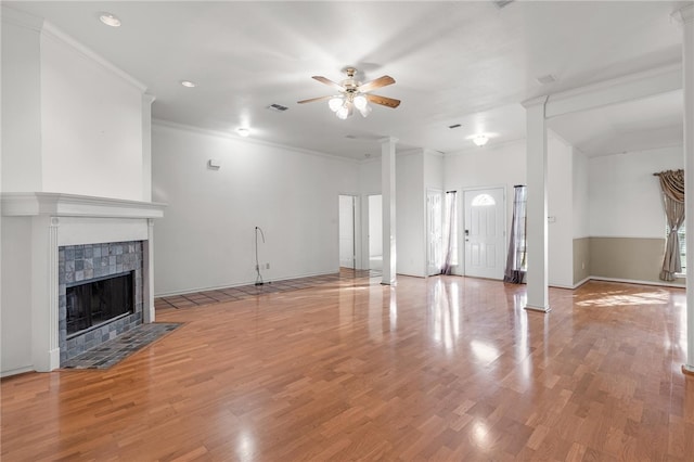 unfurnished living room with a tile fireplace, light hardwood / wood-style flooring, and ornamental molding