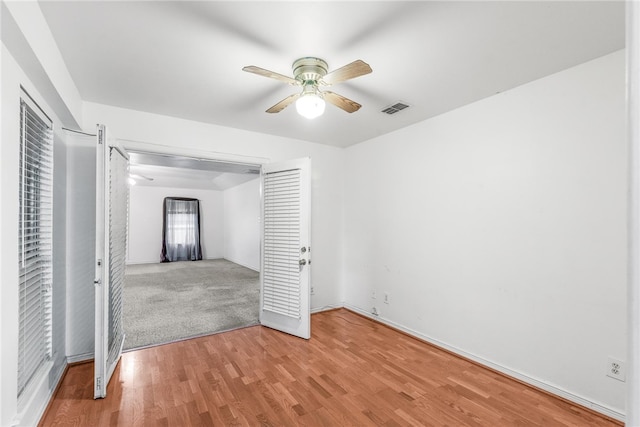 unfurnished bedroom with a closet, light wood-type flooring, and ceiling fan