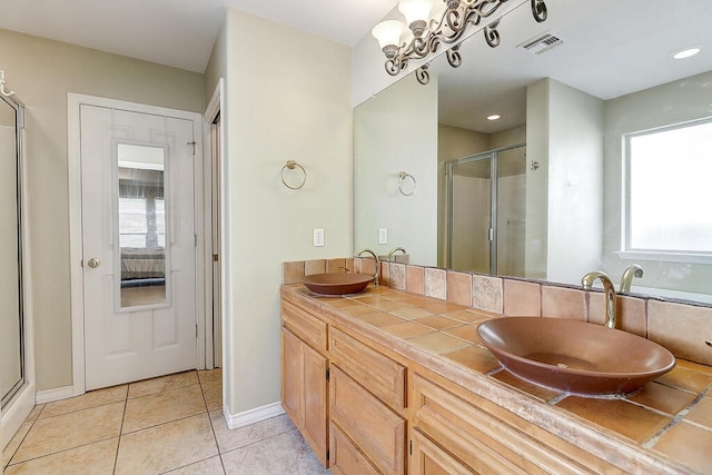6613 Belvoir Ave, Corpus Christi, TX 78414 - bathroom featuring a stall shower, plenty of natural light, double vanity, and tile patterned flooring