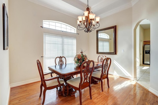 6613 Belvoir Ave, Corpus Christi, TX 78414 - dining room with arched walkways, ornamental molding, light wood-style floors, and a chandelier