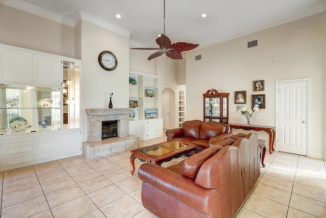 6613 Belvoir Ave, Corpus Christi, TX 78414 - living room featuring a towering ceiling, light tile patterned floors, ornamental molding, built in shelves, and ceiling fan