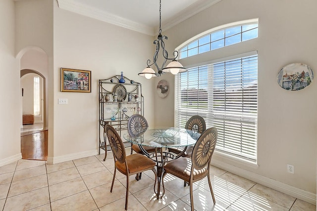 6613 Belvoir Ave, Corpus Christi, TX 78414 - dining area featuring arched walkways, crown molding, and light tile patterned flooring