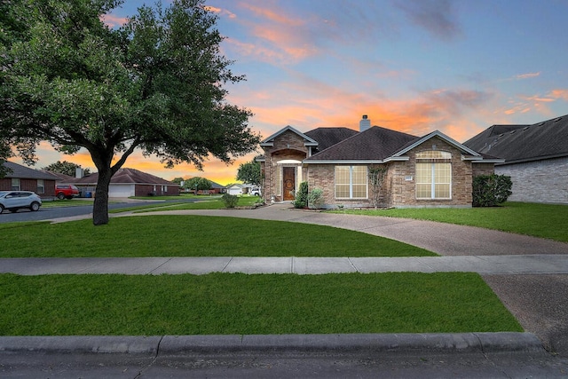 6613 Belvoir Ave, Corpus Christi, TX 78414 - view of front of house featuring a front yard, a chimney, stone siding, and roof with shingles