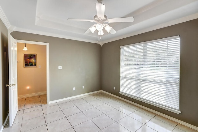 6613 Belvoir Ave, Corpus Christi, TX 78414 - spare room featuring light tile patterned floors, a ceiling fan, a raised ceiling, and crown molding