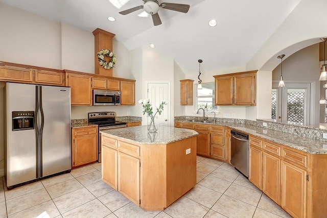 6613 Belvoir Ave, Corpus Christi, TX 78414 - kitchen featuring stainless steel appliances, a ceiling fan, a center island, light stone counters, and arched walkways