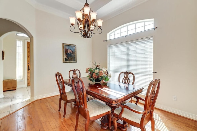 6613 Belvoir Ave, Corpus Christi, TX 78414 - dining room with arched walkways, a chandelier, and light wood finished floors