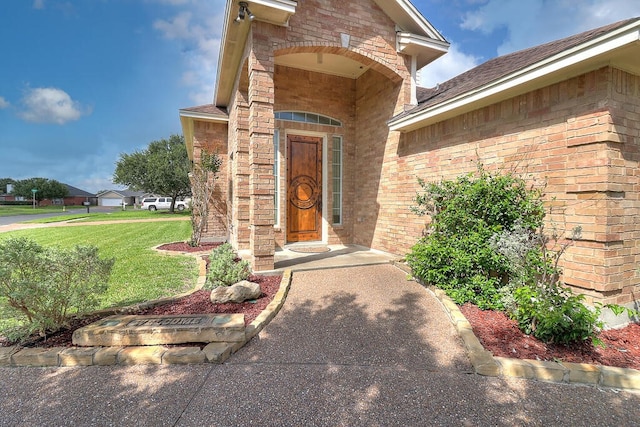 6613 Belvoir Ave, Corpus Christi, TX 78414 - view of exterior entry featuring brick siding and a lawn