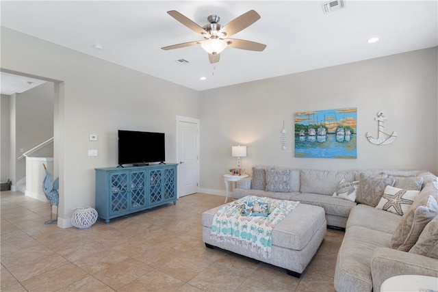 tiled living room with ceiling fan