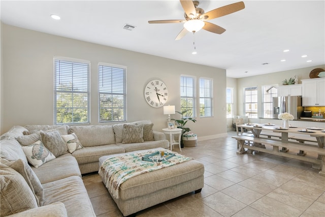 living room featuring ceiling fan and light tile patterned flooring