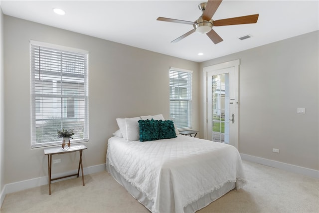 carpeted bedroom with ceiling fan and multiple windows