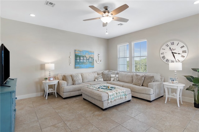 living room featuring light tile patterned flooring and ceiling fan