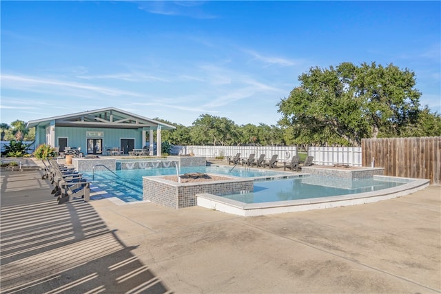 view of pool featuring a patio area and a jacuzzi