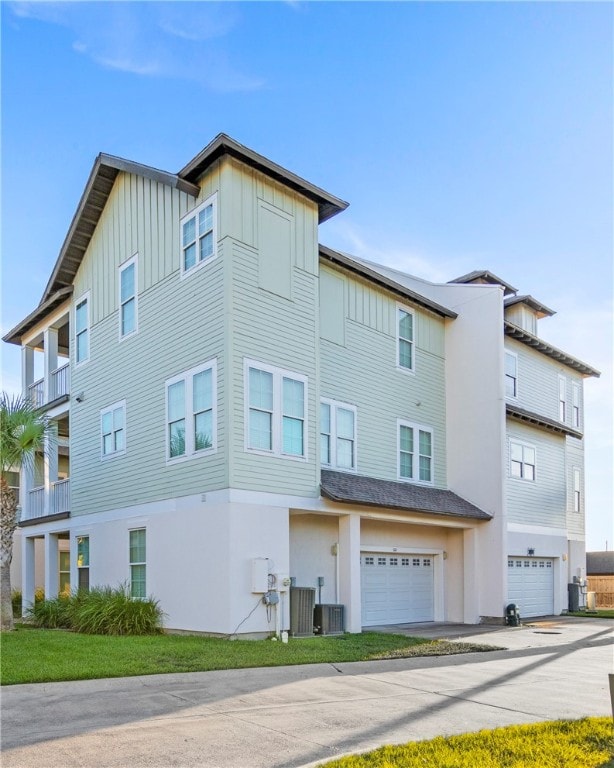 view of front of property featuring a balcony and a garage