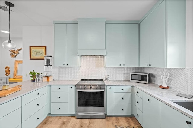 kitchen featuring custom range hood, light wood-style flooring, visible vents, and appliances with stainless steel finishes