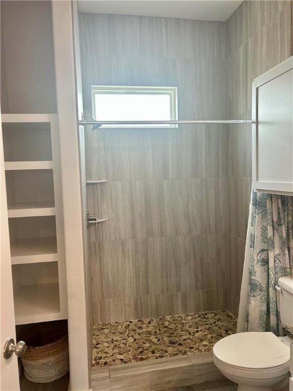15110 Arashi Beach Dr, Corpus Christi, TX 78418 - full bathroom with toilet and a stall shower