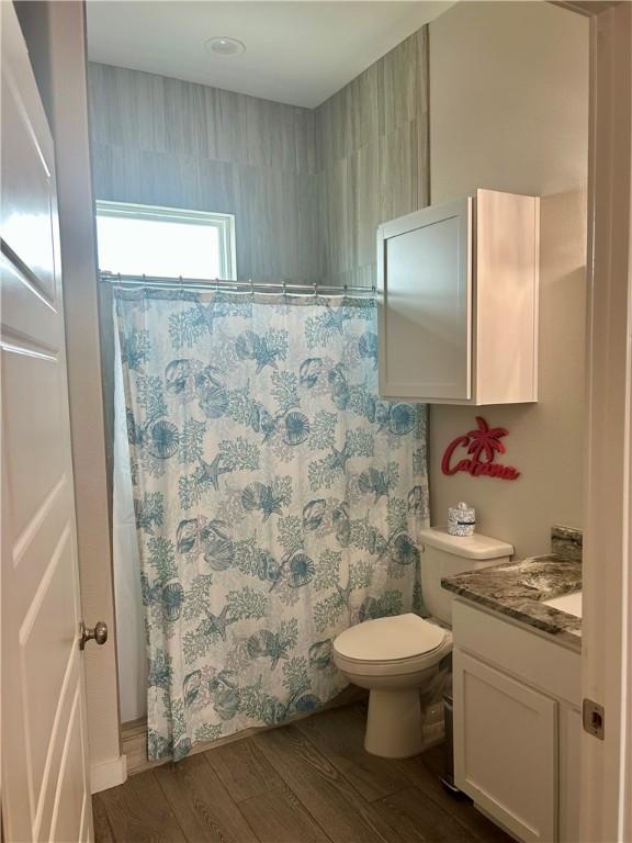 15110 Arashi Beach Dr, Corpus Christi, TX 78418 - full bathroom featuring vanity, wood finished floors, and a shower with curtain