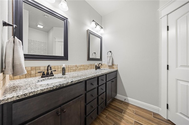 1570 Maryville Loop, Beeville, TX 78102 - full bath featuring wood finished floors, baseboards, a sink, and double vanity
