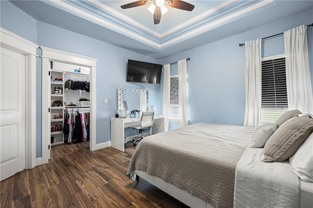 1570 Maryville Loop, Beeville, TX 78102 - bedroom with a spacious closet, wood finished floors, a closet, ceiling fan, and a raised ceiling