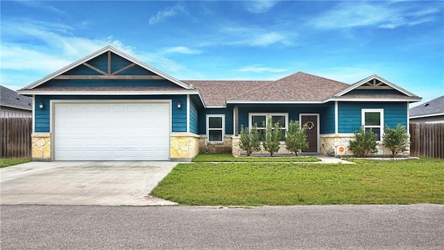 1570 Maryville Loop, Beeville, TX 78102 - craftsman-style home featuring driveway, stone siding, a front lawn, and fence