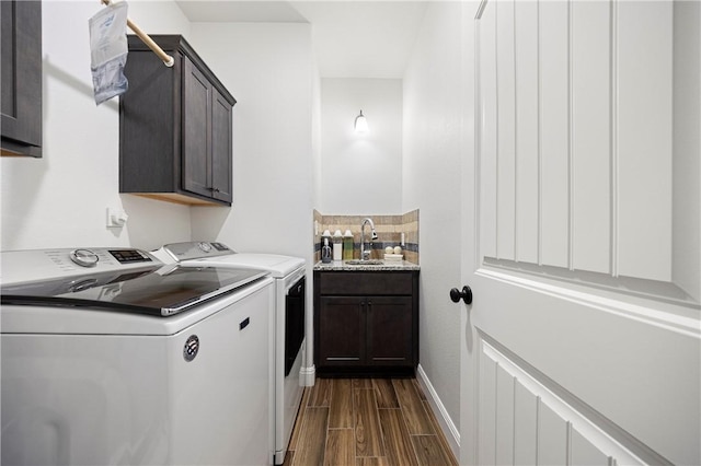 1570 Maryville Loop, Beeville, TX 78102 - laundry room with dark wood-style floors, a sink, baseboards, washer and dryer, and cabinet space