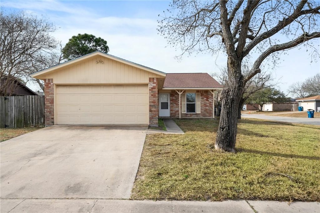 single story home featuring a garage and a front yard