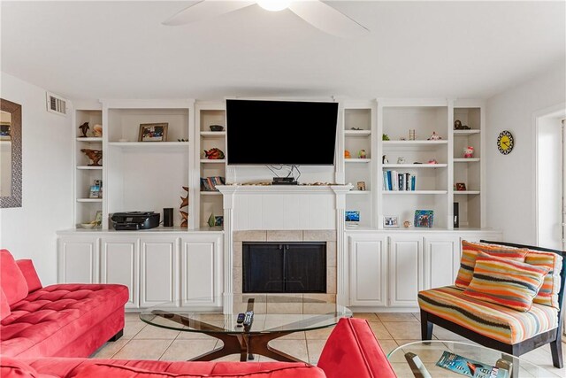 700 Island Retreat Rd Unit 138, Port Aransas, TX 78373 - living area featuring light tile patterned flooring, ceiling fan, and a fireplace