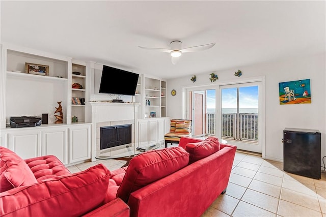700 Island Retreat Rd Unit 138, Port Aransas, TX 78373 - living room with ceiling fan, a fireplace with flush hearth, and light tile patterned floors