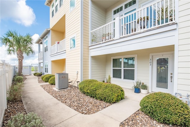 view of property exterior featuring central AC and a balcony