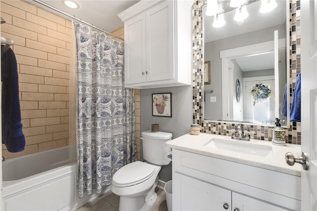 full bathroom with tile patterned floors, backsplash, vanity, toilet, and shower / bath combo with shower curtain