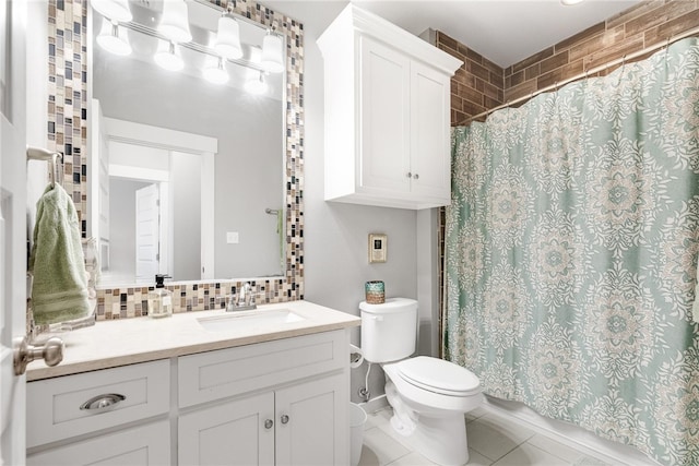 bathroom featuring tasteful backsplash, walk in shower, vanity, tile patterned flooring, and toilet