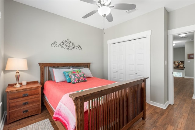 bedroom featuring ceiling fan, a closet, and dark hardwood / wood-style flooring