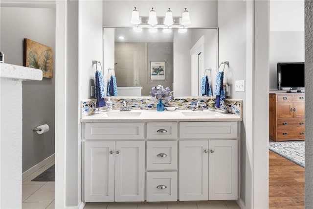 bathroom featuring walk in shower, hardwood / wood-style floors, and vanity